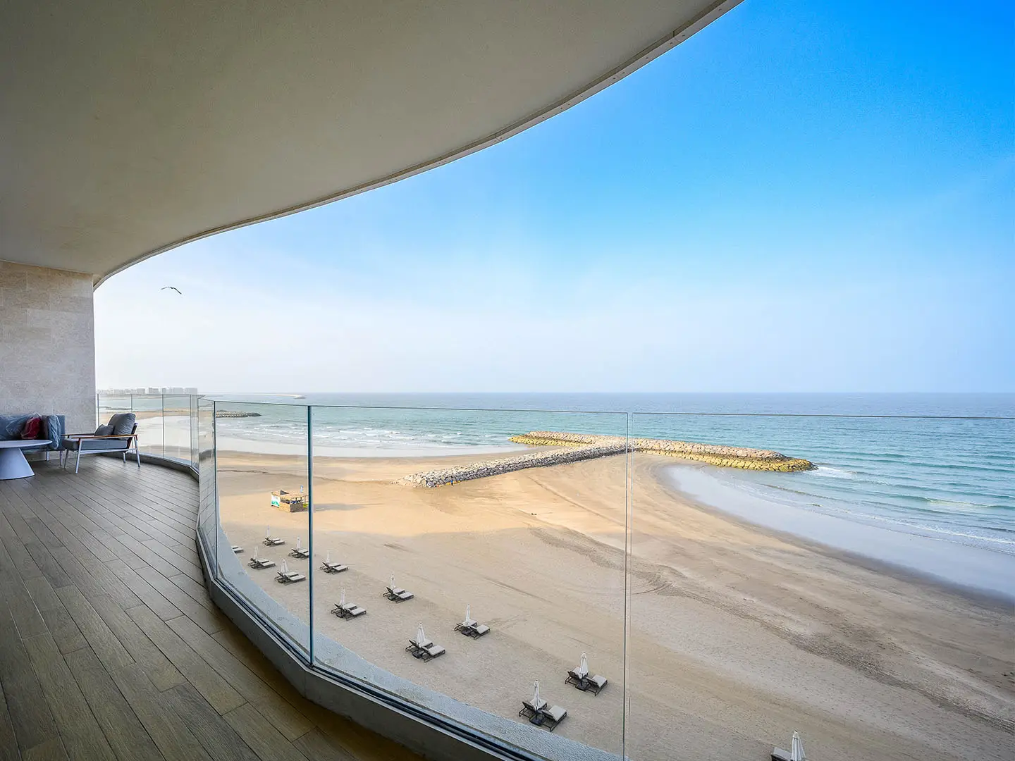 Curved balcony overlooking beach and ocean