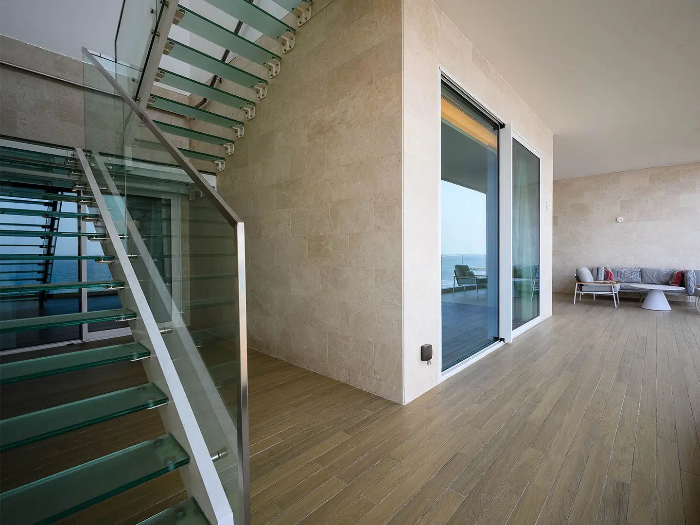 Modern interior with glass staircase, ocean view