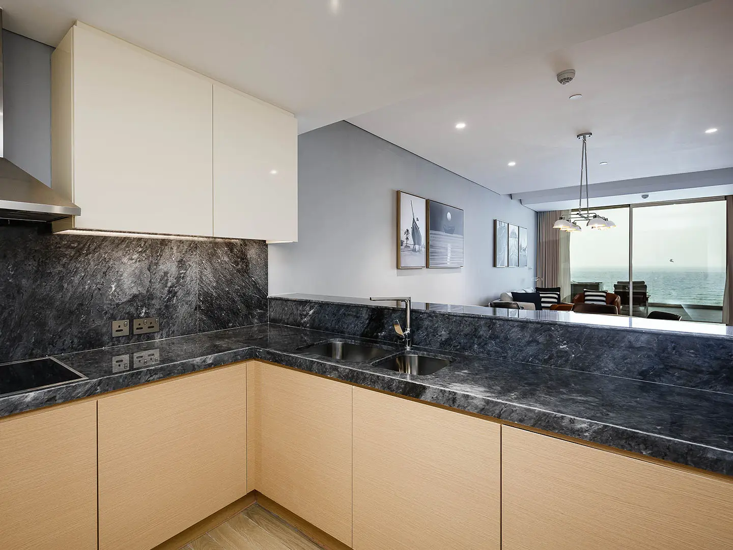A modern kitchen with a view of the living room