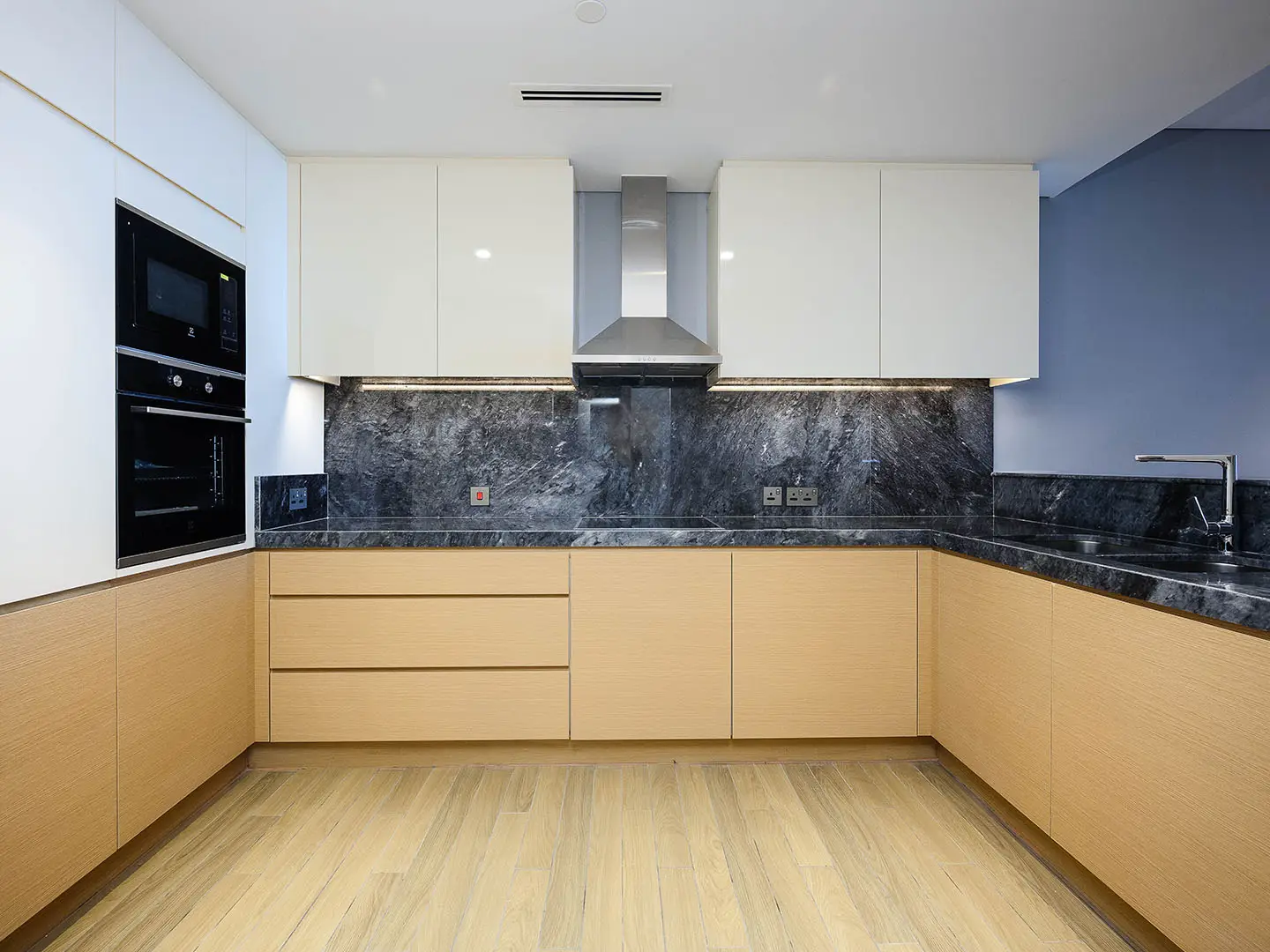 Kitchen with wood, white cabinets, marble