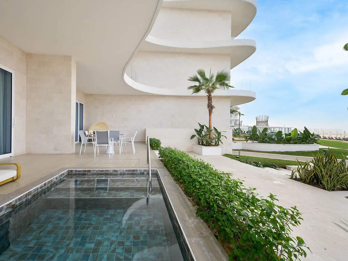 A patio with a pool and outdoor dining area