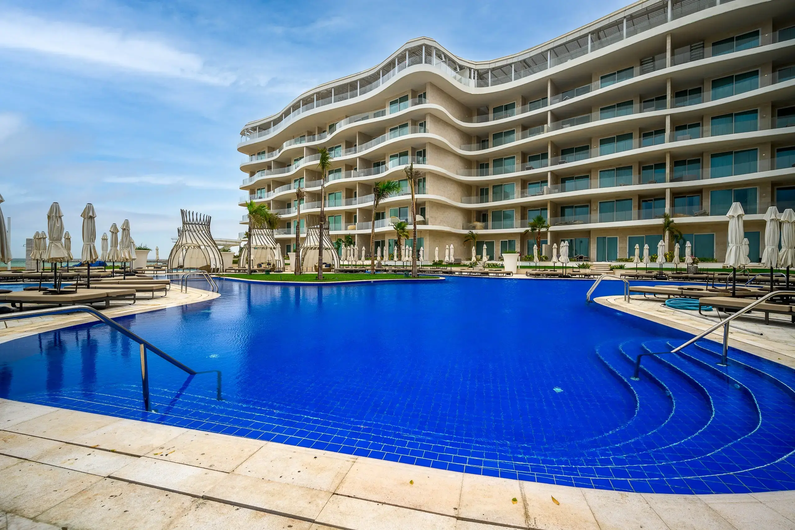 Elegant hotel pool surrounded by modern architecture