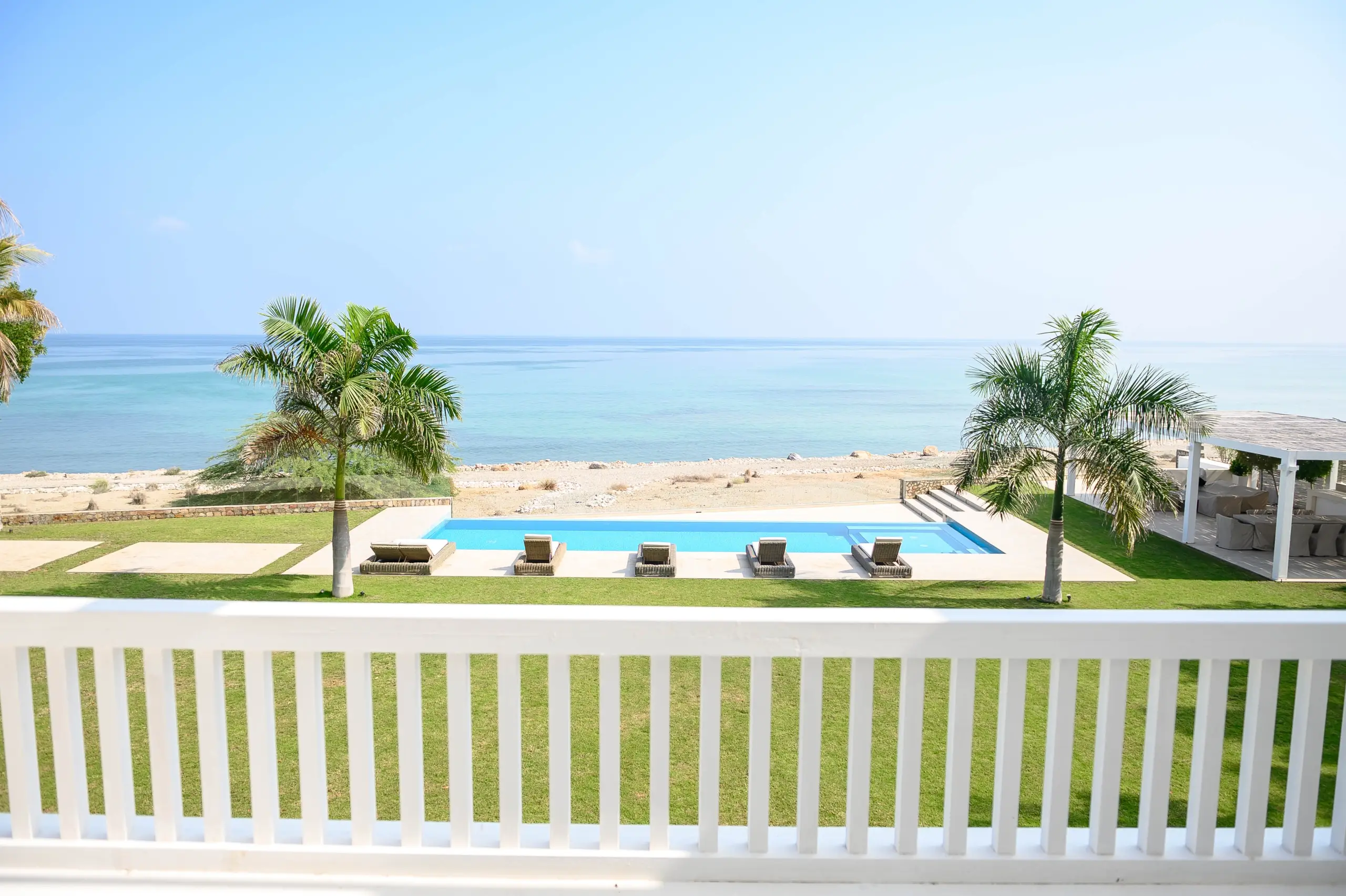 A beautiful beachfront pool area with palm trees